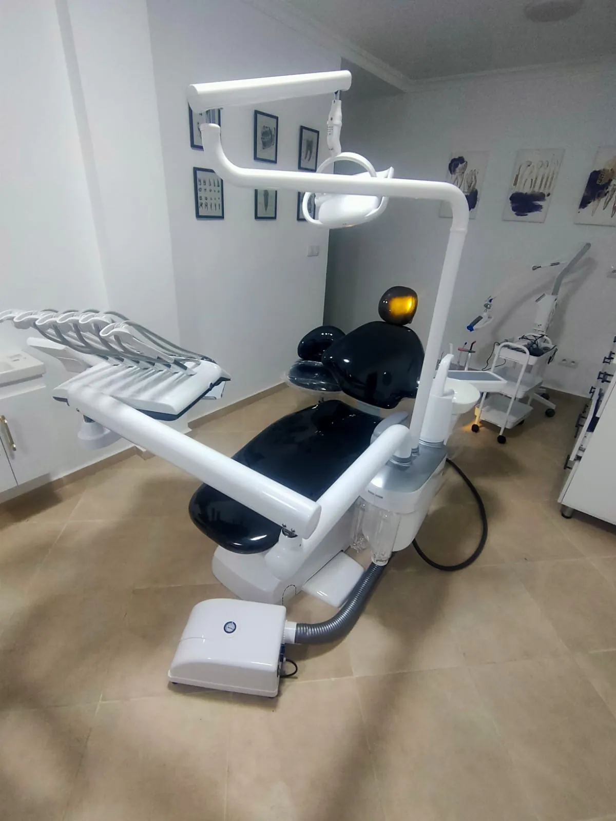 Fauteuil dentaire noir installé dans un cabinet moderne